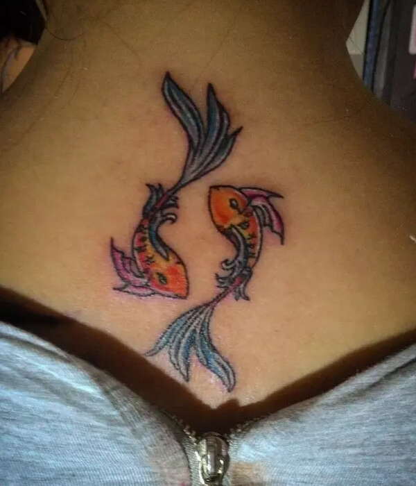 A stunning symmetrical back Pisces tattoo