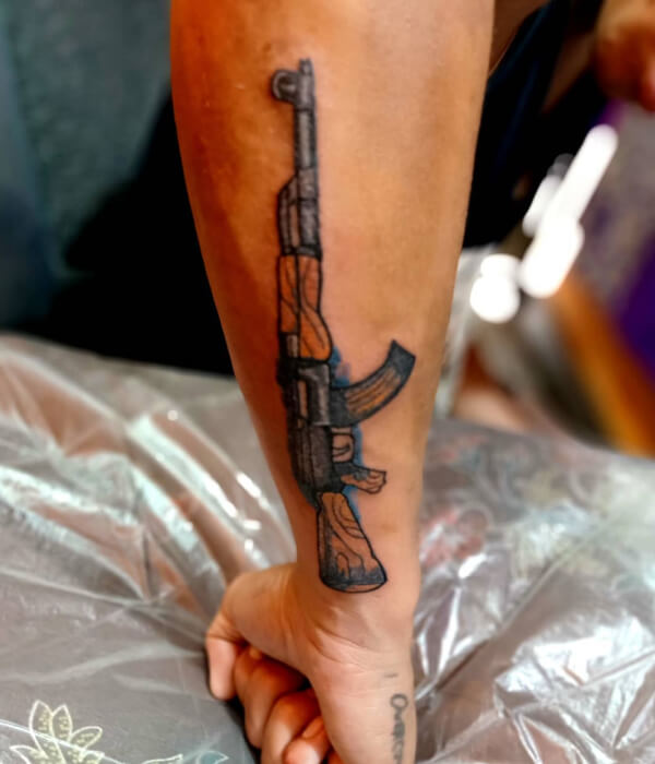 AK 47 tattoo in black and brown