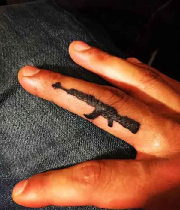 AK 47 tattoo on fingers