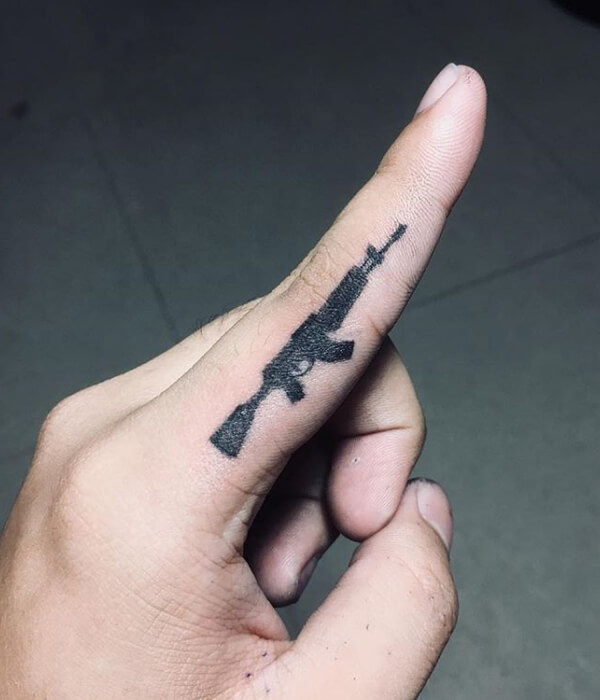 AK 47 tattoo on fingers