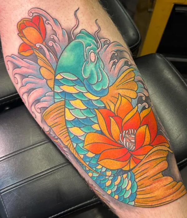 An intricate fish and water lily sleeve tattoo