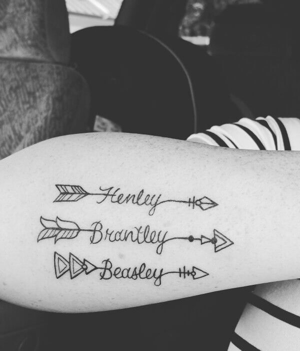 Arrow with baby name tattoo