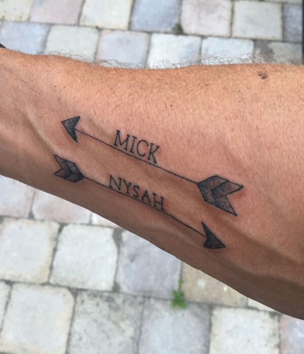 Arrow with baby name tattoo