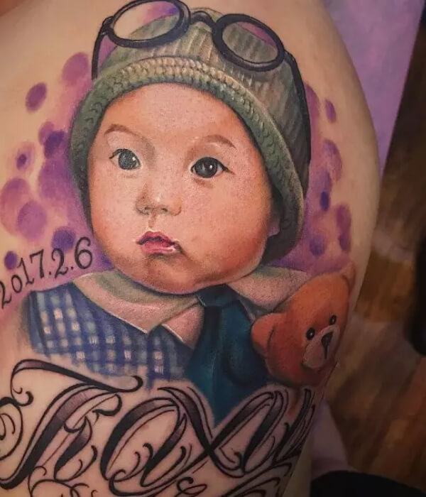 Baby face with name tattoo