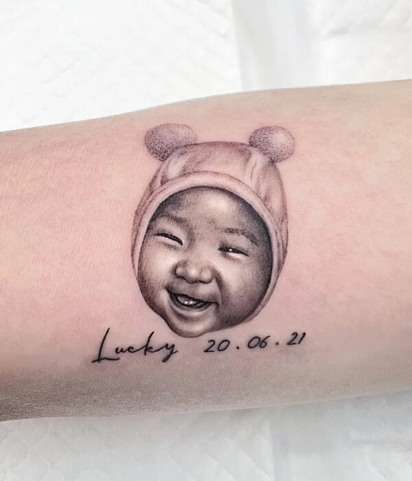 Baby face with name tattoo