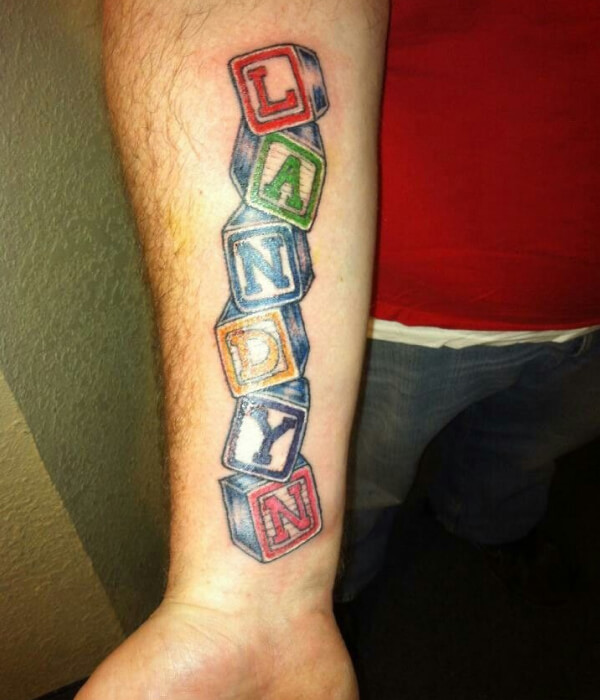 Block letter baby name tattoo