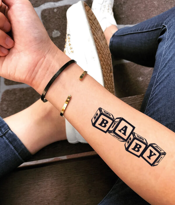 Block letter baby name tattoo