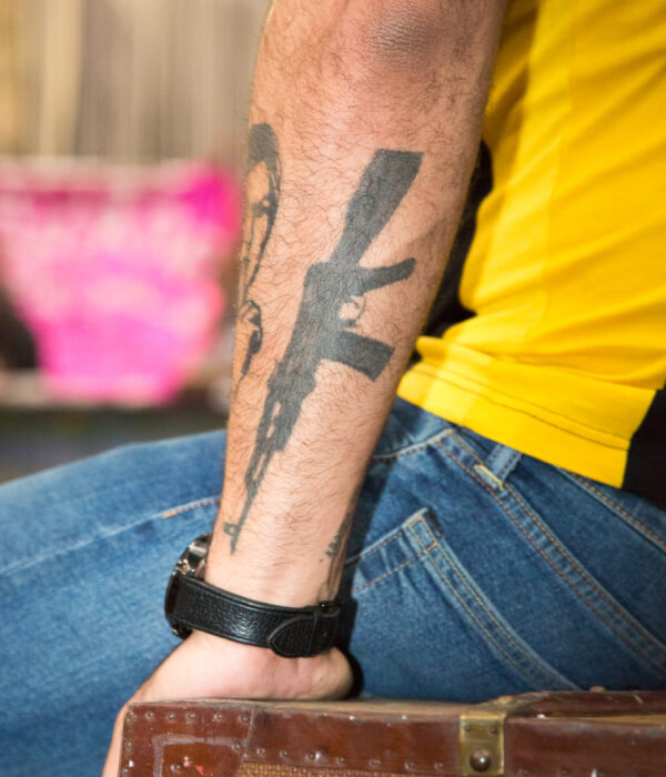 Bright AK 47 tattoo on the arm