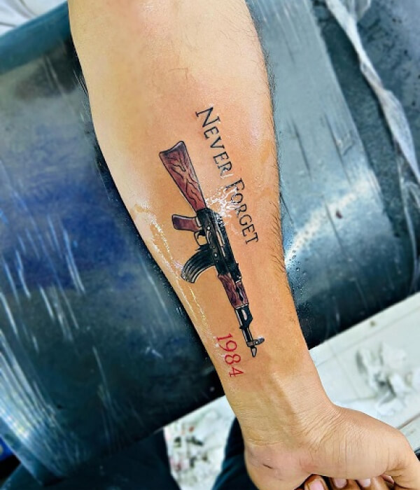 Bright AK 47 tattoo on the arm