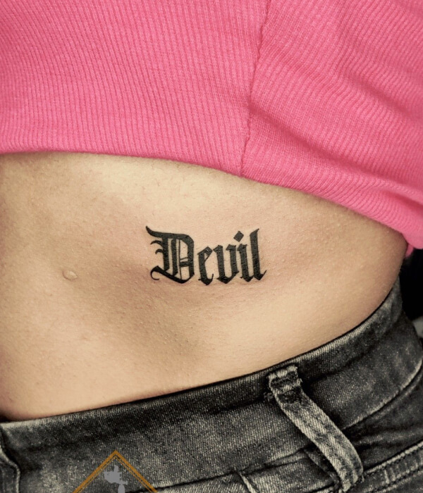 Lower waist devil tattoo