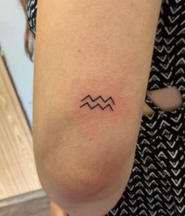 Minimalistic Aquarius tattoo on the wrist