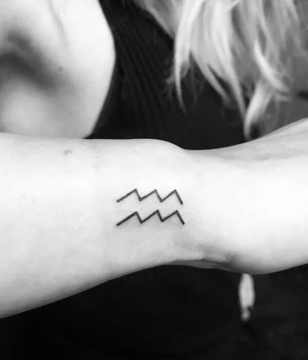 Minimalistic Aquarius tattoo on the wrist