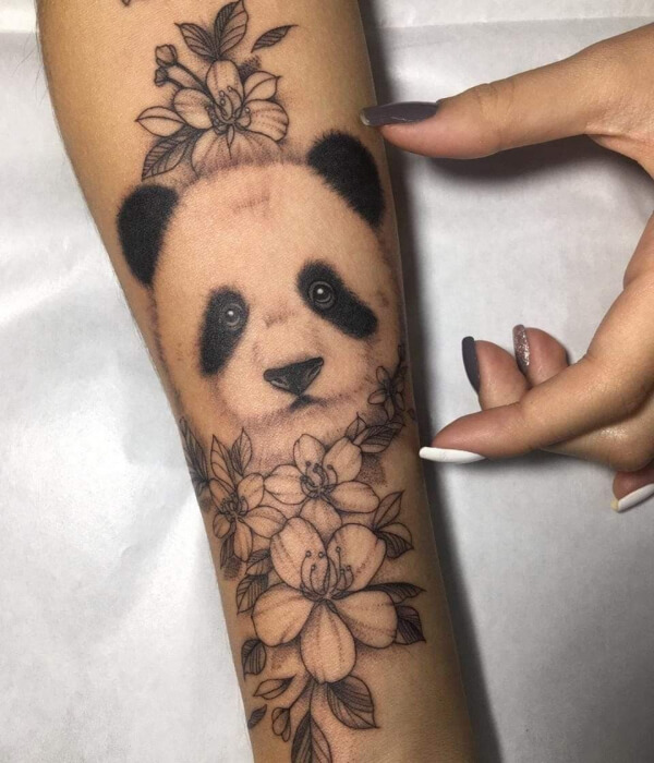 Panda tattoo with flowers