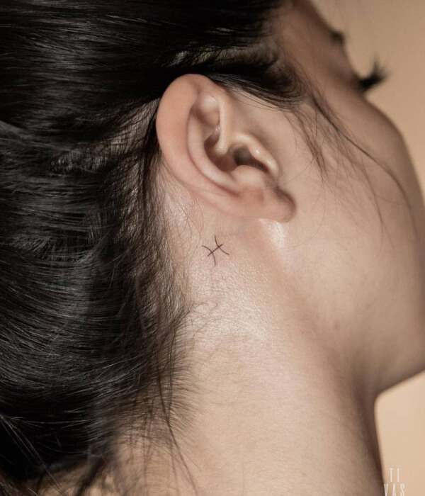 Pisces glyph tattoo behind the ear