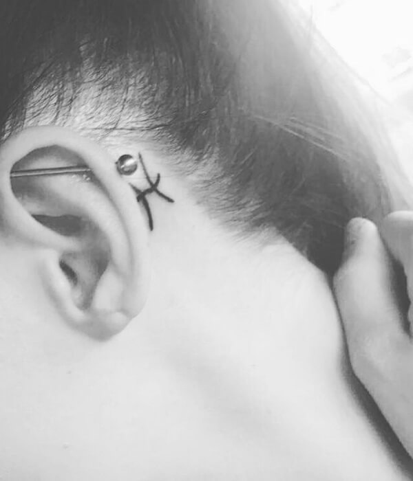 Pisces glyph tattoo behind the ear