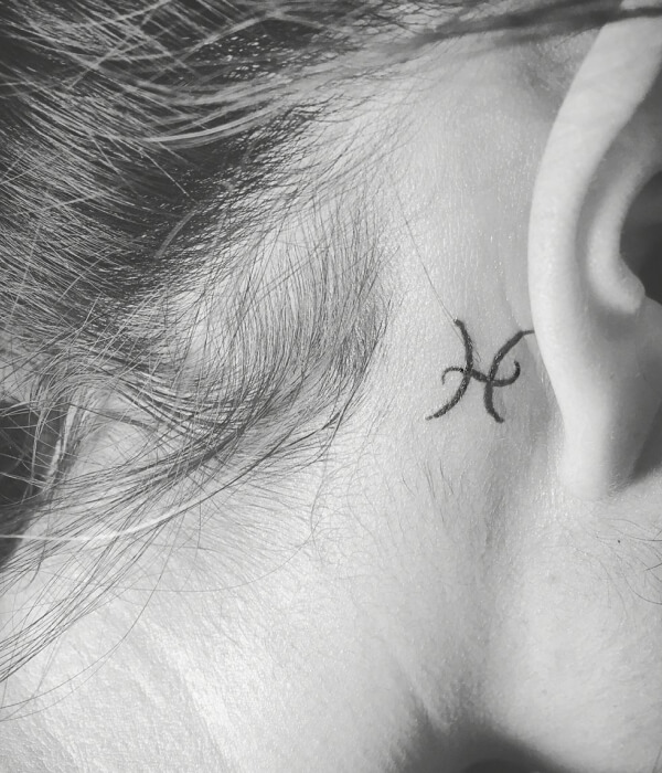 Pisces glyph tattoo behind the ear