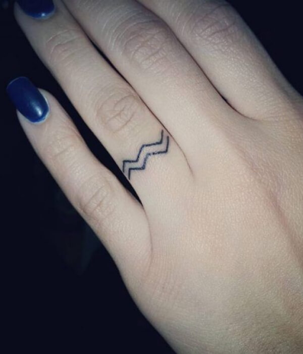 Small Aquarius symbol on the finger