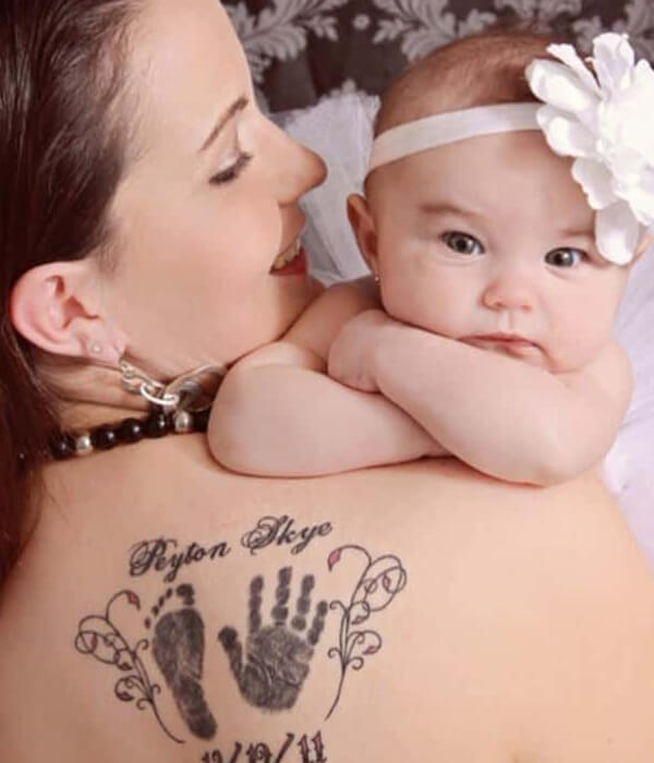 Two kids names with a handprint and footprint tattoo