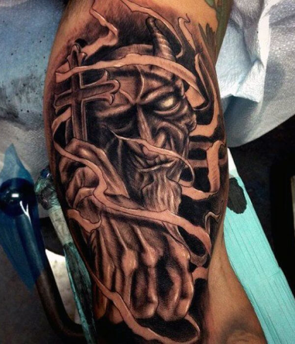 Upper arm devil tattoo