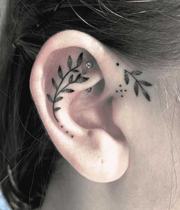 A small plant near the ear tattoo