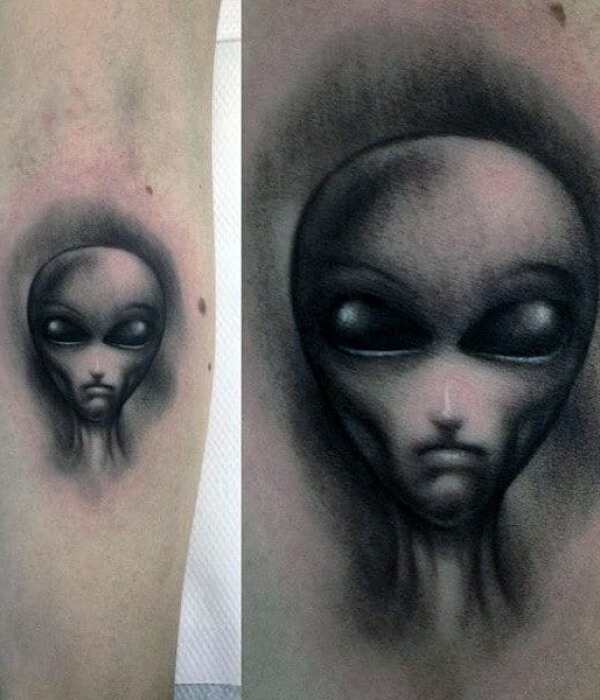 Alien head tattoo