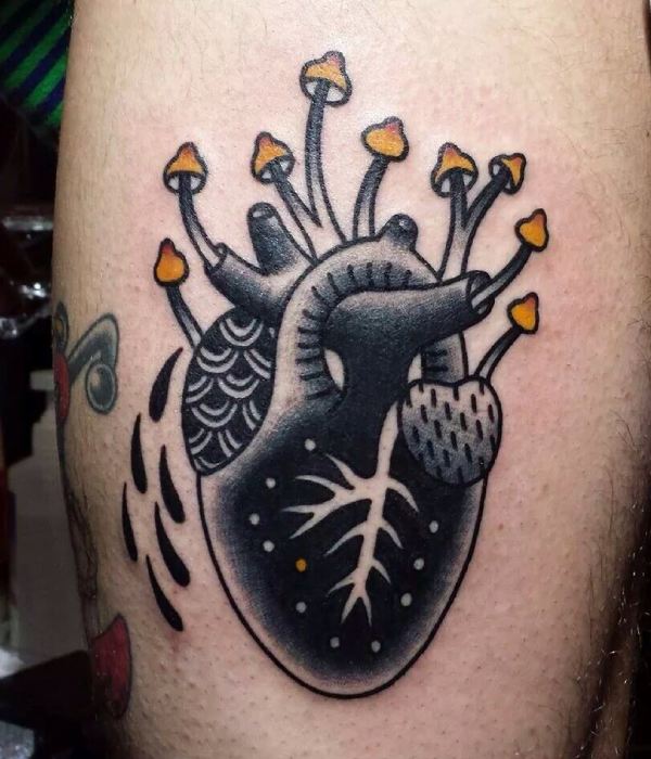 Heart with mushroom and plant tattoo