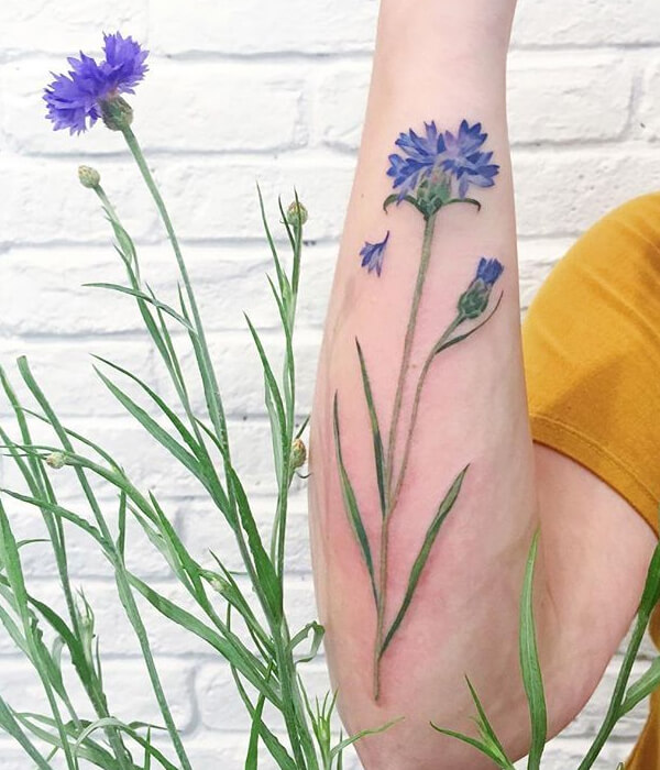 Blue daisy tattoo