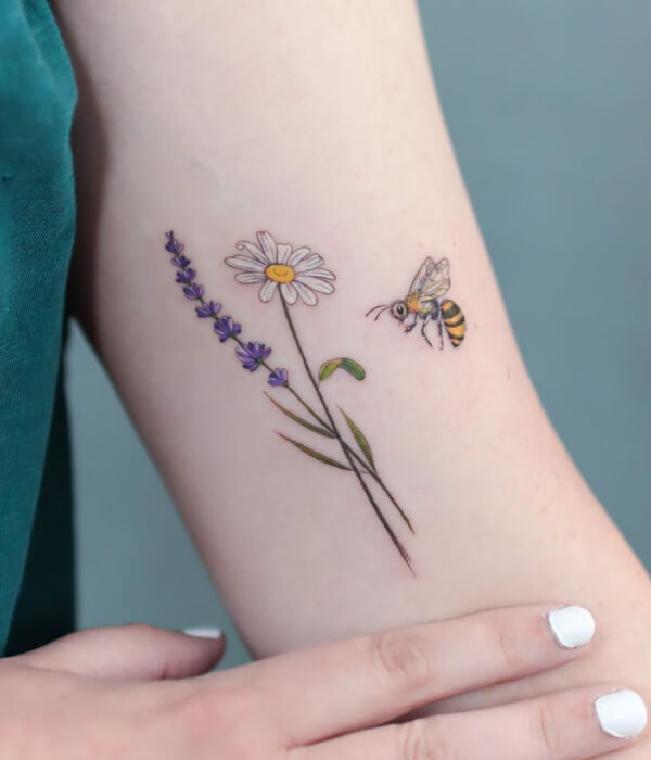 Daisy tattoo with a bee