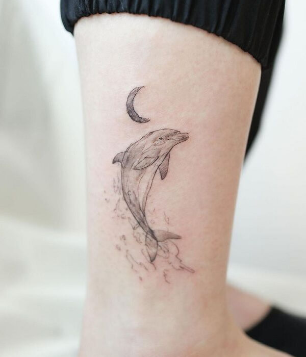 Dolphin tattoo with crescent moon