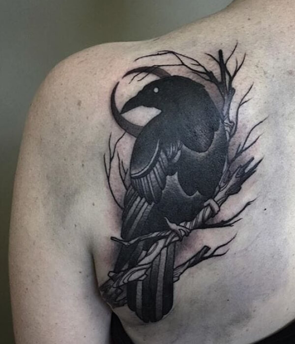 Gray and black raven tattoo