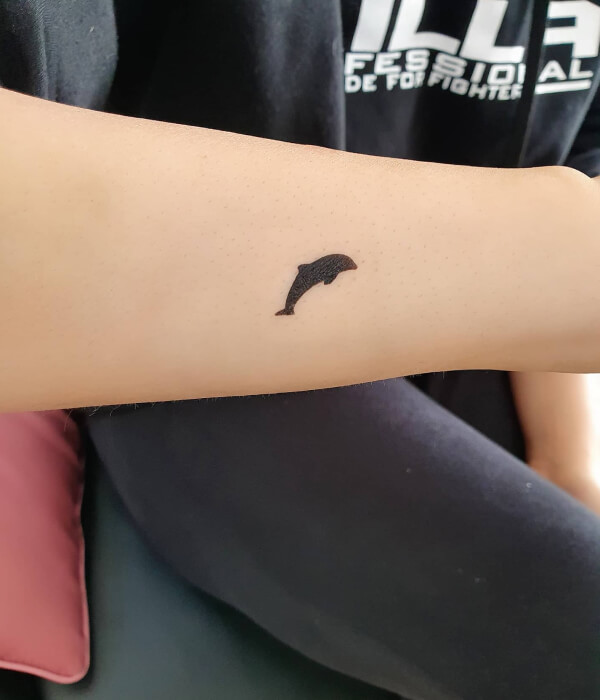 Minimalistic dolphin tattoo designs