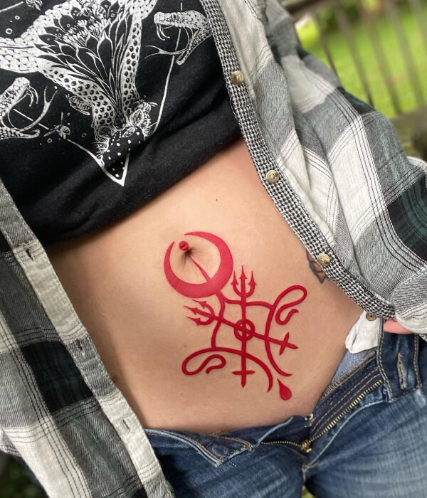 Red ink womb tattoo