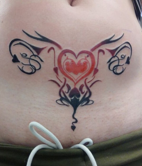 Red ink womb tattoo