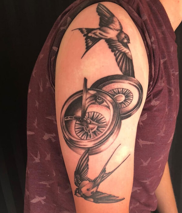 Swallow tattoo with compass