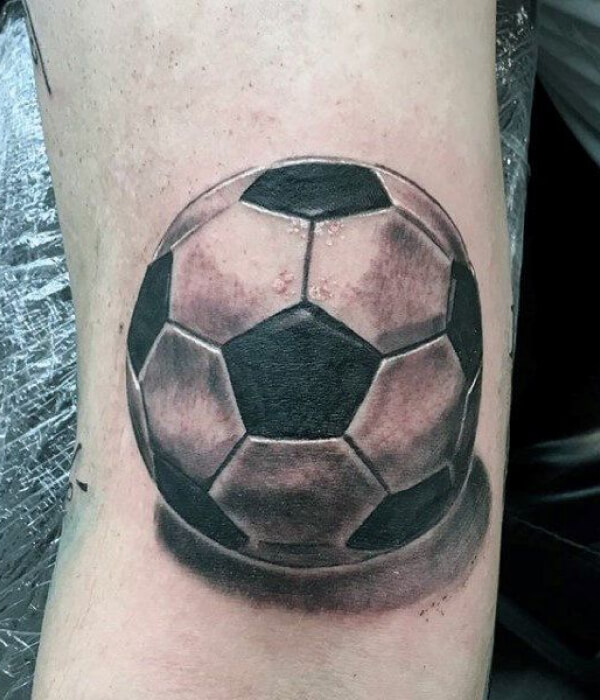 Black and gray soccer ball tattoo