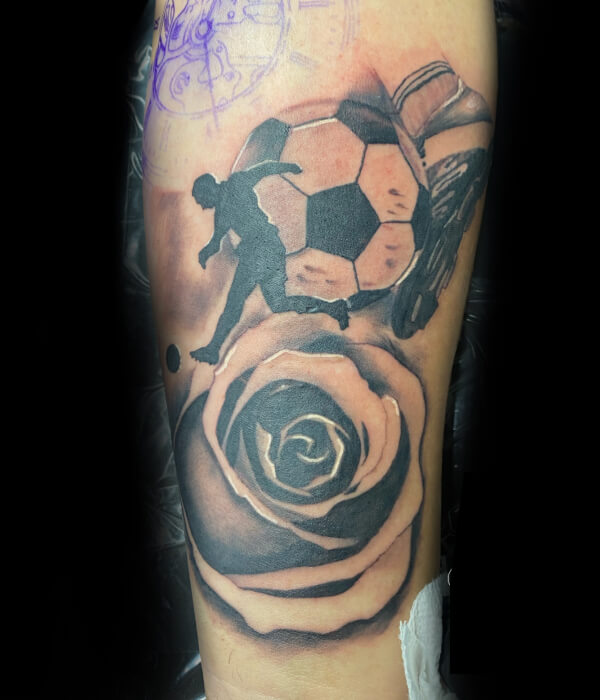 Football hand tattoo with roses