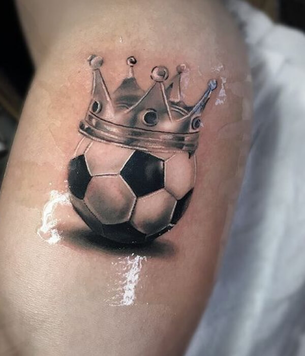 Football with crown hand tattoo