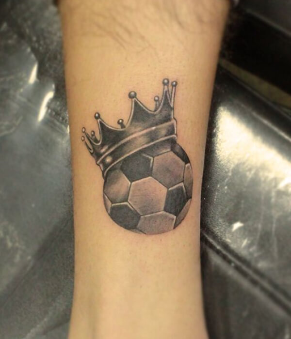 Football with crown tattoo