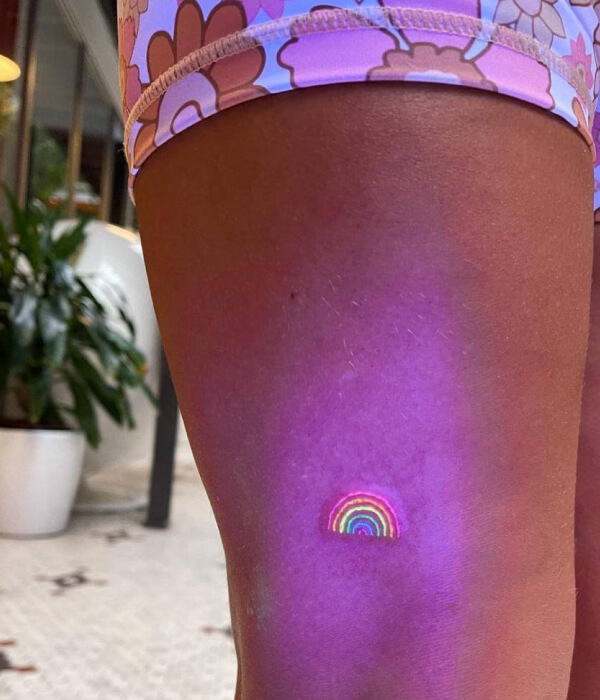 Rainbow UV on leg Tattoo