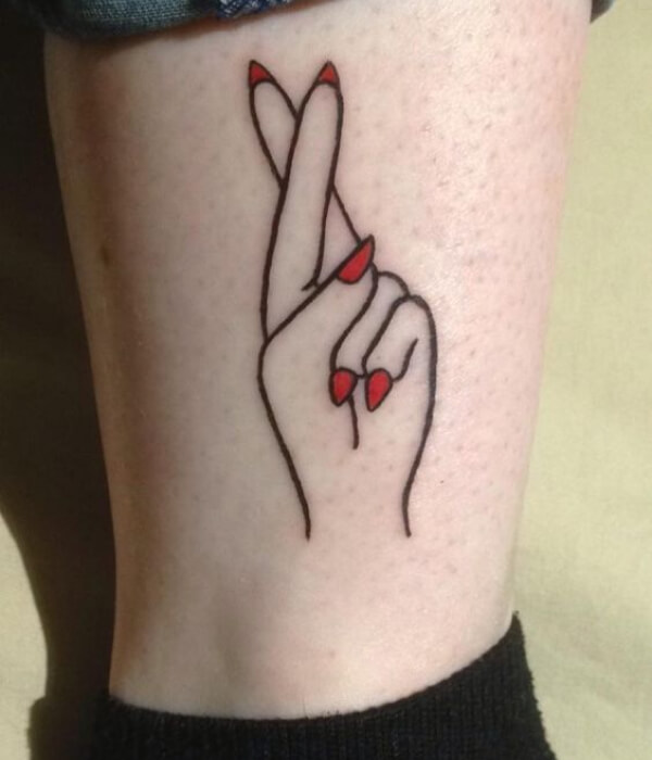 Finger Crossed Tattoo with Red Nails ideas