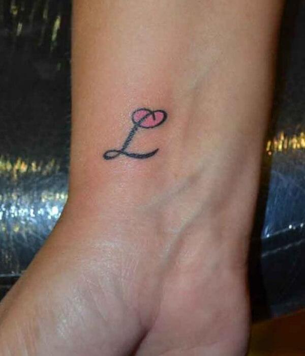 Script T letter tattoo