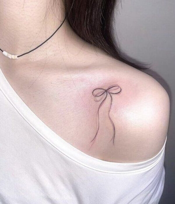 Bow tattoo on collarbone