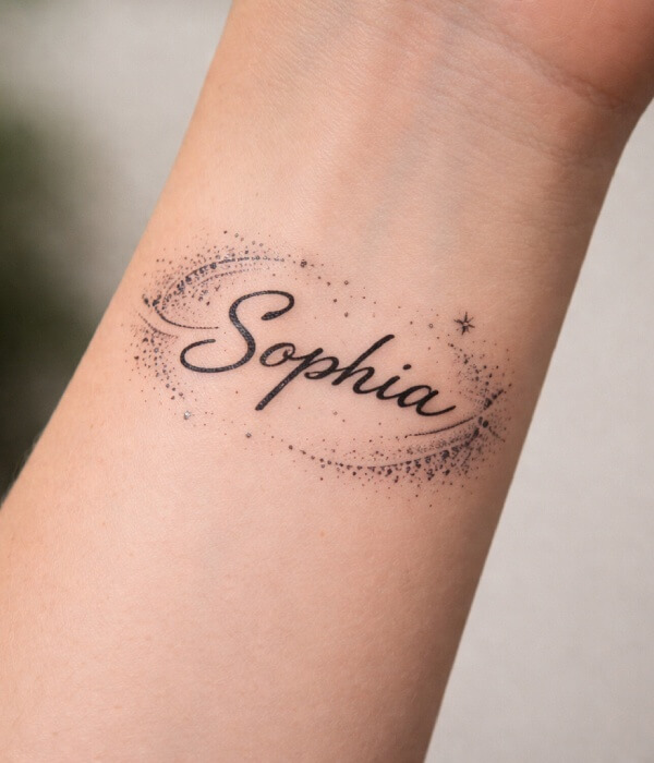 Dot-work name tattoo on the wrist featuring the name “Sophia” in elegant cursive, surrounded by delicate black dot patterns that add depth and a modern, minimalist look.