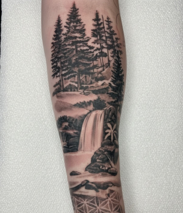 Minimalist fine-line forearm tattoo of a tree split by a geometric frame, showing seasonal change from orange leaves to bare branches