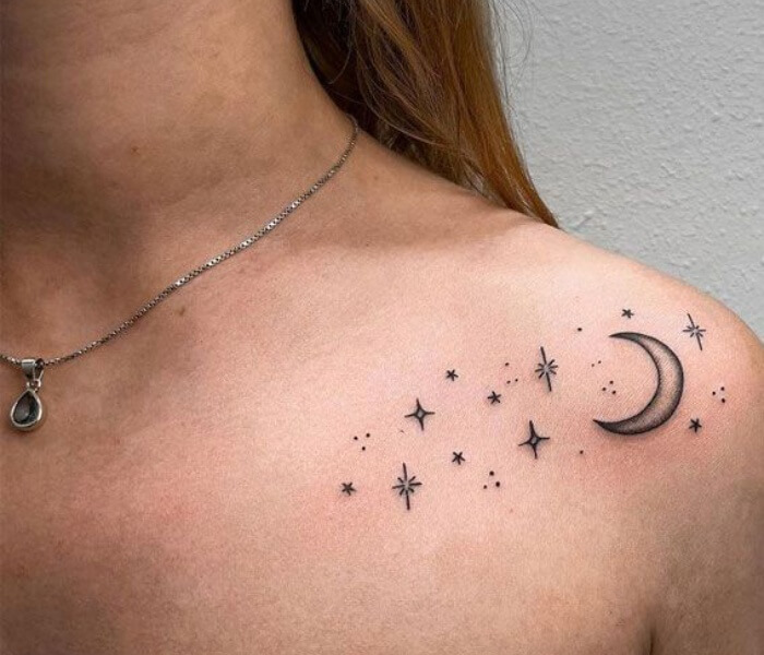 Tiny Zodiac Line Tattoo - Trending Tattoo Tiny zodiac line tattoo featuring a crescent moon and scattered stars delicately inked along the collarbone.