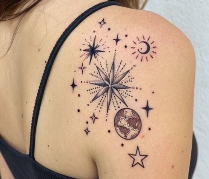 Tiny Zodiac with Stars Tattoo 1 - Trending Tattoo Tiny zodiac-inspired tattoo with stars, crescent moon, compass star, and celestial elements delicately inked on the shoulder.