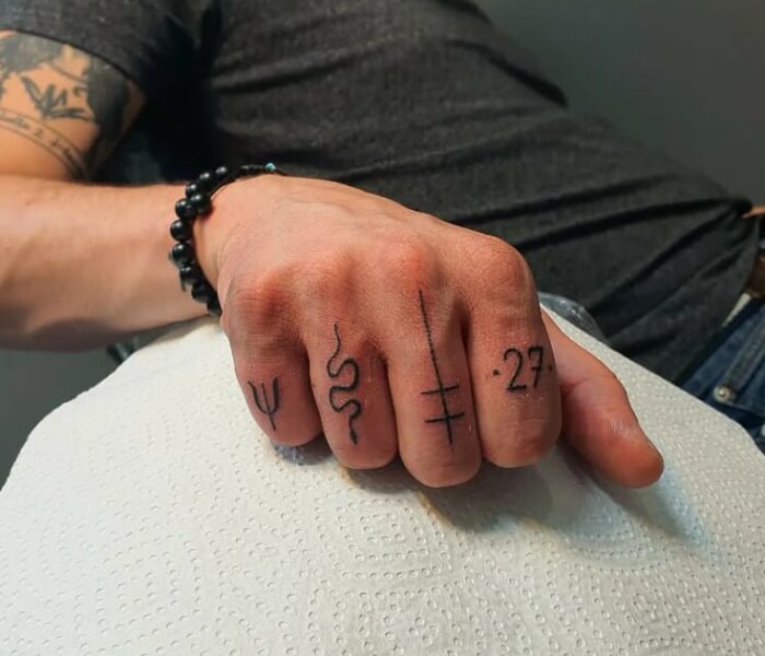 Zodiac Tattoos on the Side of the Finger - Trending Tattoo Zodiac symbol finger tattoos featuring minimalist astrological glyphs, numbers, and fine-line designs inked on the side of the fingers.